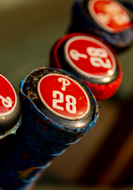 The butt ends of baseball bats with the Philadelphia Phillies logo on them